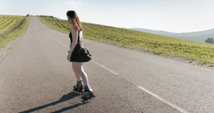 Beautiful young woman dancing on roller skates