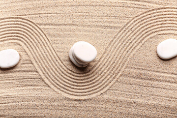 White stones on sand with lines. Zen concept