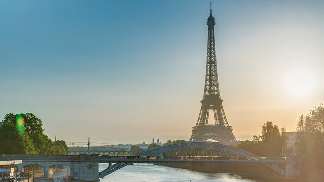 Eiffel Tower sunrise timelapse with boats on Seine river and in Paris, France.