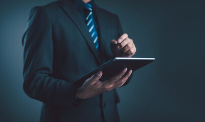 Businessman using digital tablet with stylus pen, representing technology, communication,...