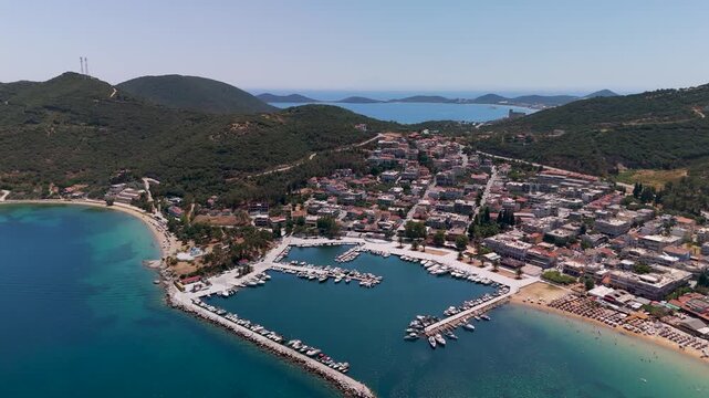 Aerial drone view showcasing the busy fishing and yacht marina of Nea Iraklitsa resort town in Kavala, Eastern Macedonia, Greece.