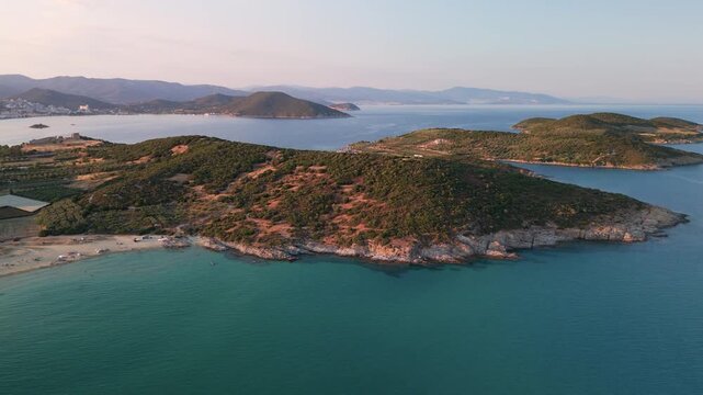 High angle aerial drone flight over the rugged Vrasidas coastline, showcasing the mountainous landscape meeting the deep blue Thracian Sea in Eastern Macedonia, Greece.