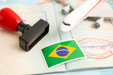 Brazil flag and passport with airplane for travel.