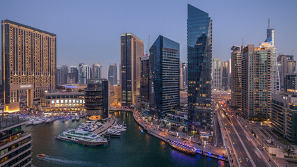 Naklejka premium Beautiful aerial top view day to night transition timelapse of Dubai Marina canal