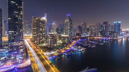 Fototapeta premium Beautiful aerial top view day to night transition timelapse of Dubai Marina canal