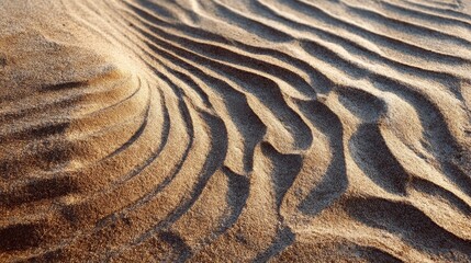 Detailed view of undulating sand designs on a shoreline