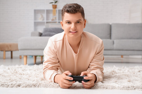 Teenage boy playing video games at home
