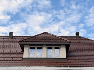 Finished look of the house with the second story installed, featuring natural brown roof tiles and a double-height living area.
