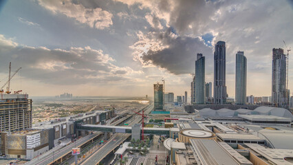 Sunrise aerial view of Financial center road morning timelapse with under construction building