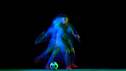 Female soccer player dribbling ball in green and blue motion trail. Concept of coordination, agility drills, sport advertising visuals, and athletic performance promotion.
