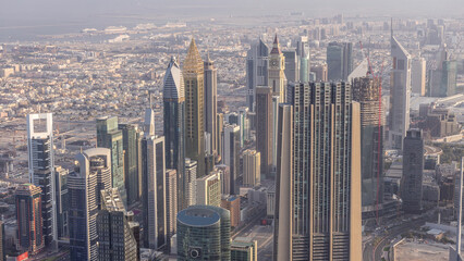 Fototapeta premium Downtown of Dubai in the morning timelapse after sunrise. Aerial view with towers and skyscrapers