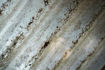Textured surface with subtle waves, showcasing abstract patterns. Dominantly white, with dirt and...