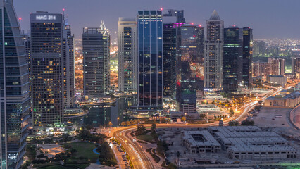 Obraz premium Jumeirah Lake Towers residential district aerial day to night timelapse near Dubai Marina