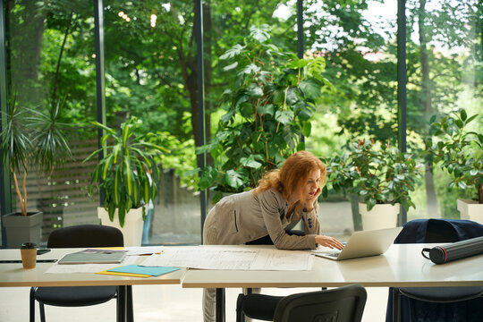 Adult woman deeply focused on work in coworking area