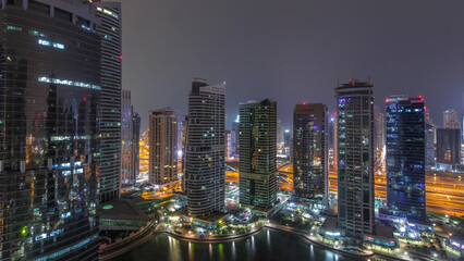Obraz premium Residential and office buildings in Jumeirah lake towers district night timelapse in Dubai