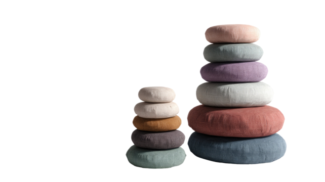 Stack of smooth natural stones arranged for balance harmony calm meditation spa wellness relaxation decor isolated on white background