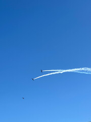 Two Airplanes Leaving Contrails in Formation in Clear Blue Sky