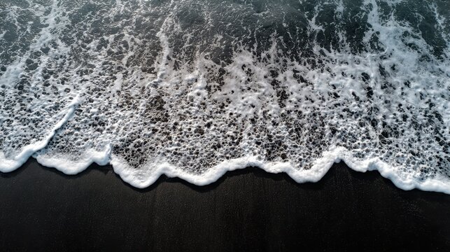 Bali s Canggu features foamy seawater on a black sand beach photographed from above to highlight its texture and tranquility ideal for nature and travel themes - Powered by Adobe