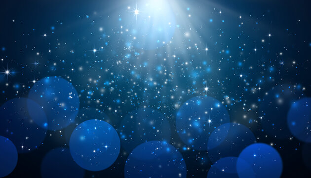 Magical blue light rays shining through sparkling particles
