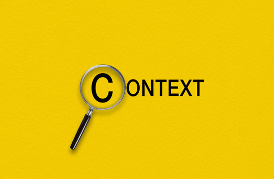 Magnifying glass focusing on the word Context. Contextual advertising concept 