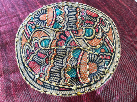 Detailed close-up of a circular floral motif accentuated with delicate Kantha hand embroidery highlighting its intricate texture.