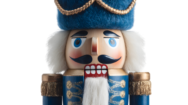 Classic nutcracker soldier in blue uniform and white beard isolated on white background