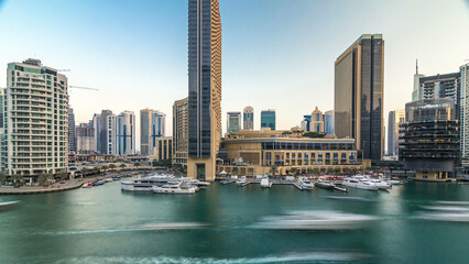 Obraz premium Aerial view of Dubai Marina with shopping mall, restaurants, towers and yachts timelapse, United Arab Emirates.