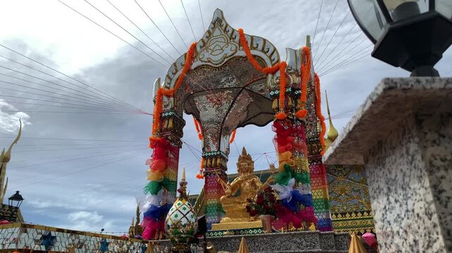 Golden Phra Phrom Statue at Colorful Thai Shrine under Cloudy Sky at PIK 2