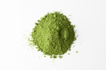 Bright green matcha powder forms a small mound on clean white background, creating contrast and highlighting organic texture.