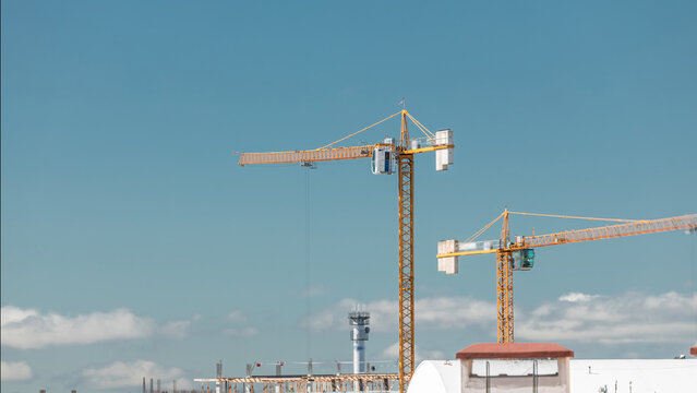 Timelapse of construction site with cranes working on a building complex.
