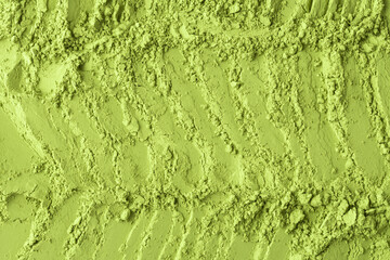 Loose matcha powder arranged in wavy textured lines provides a vivid, fresh background for creative culinary, health, and beauty content.
