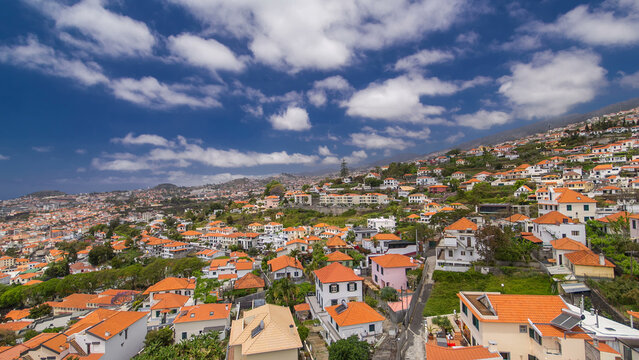 Aerial view from the mountain over the rooftops from cable car on Madeira timelapse hyperlapse. - Powered by Adobe