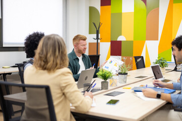 Business colleagues collaborating on data analysis in office