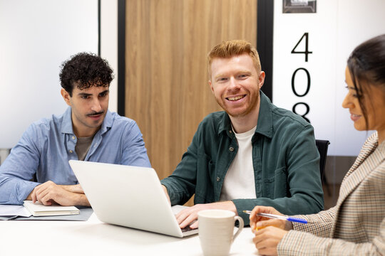 Diverse business team collaborating in modern office meeting