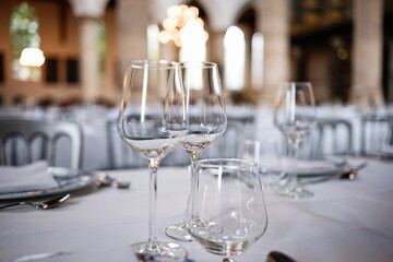 Empty wine glasses on a set, formal dinner table. Close up shot, shallow depth of field, no people