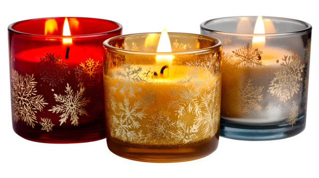 Christmas candles in glass holders glowing warmly isolated on white background