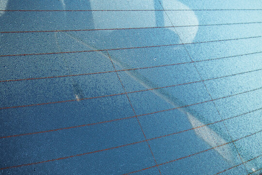 Dew, mist or condensation inside a car's rear windshield. Exterior shot, early autumn day, close up, no people