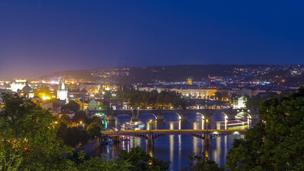 Obraz premium Scenic view of bridges on the Vltava river day to night timelapse and of the historical center of Prague: buildings