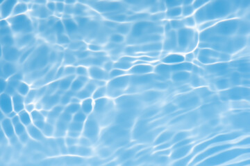 Blue water with ripples on the surface. Defocus blurred transparent blue colored clear calm water surface texture with splashes and bubbles. Water waves with shining pattern texture background.