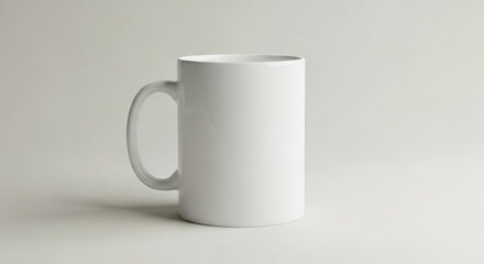 Obraz premium A minimalist white ceramic mug casts a soft shadow on a clean, neutral background, ideal for showcasing branding or a simple, clean aesthetic