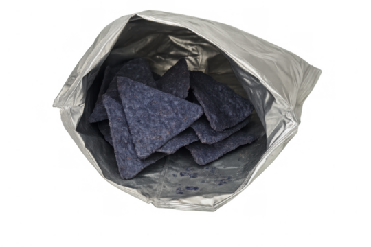 Blue corn tortilla chips filling an opened silver snack bag against a transparent background