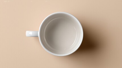Top Down View of Clean Empty White Coffee Mug on Minimalist Light Beige or Cream Background with Copy Space