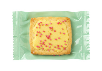Isolated square shortbread cookie topped with frosting and pink sprinkles on wrapper