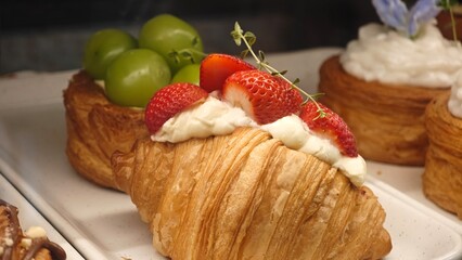 Fresh Croissant with Whipped Cream and Strawberries.
