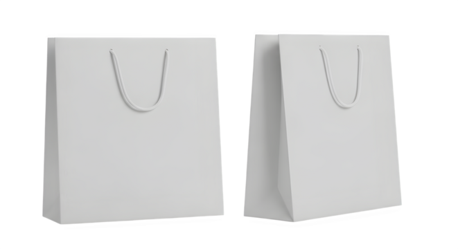 Two plain white paper shopping bags with handles isolated on a black background