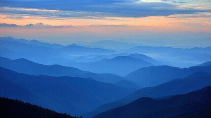 Serene Blue Hues of Distant Mountain Ranges Under Soft Sunrise Light in Atmospheric Landscape Setting