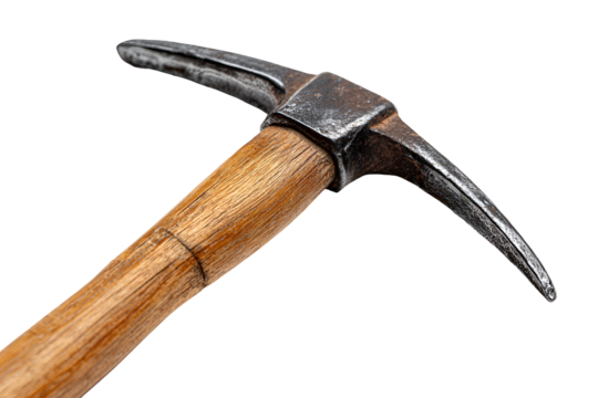 Close up of an antique pickaxe with a wooden handle on a black background