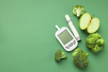 Fresh green broccoli and apple alongside a glucose meter