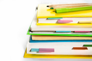 Notepad, notebooks, textbooks and books with bookmarks and stickers. The concept of diligent study