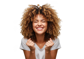 Joyful young woman with curly hair expressing triumph and excitement with closed eyes and clenched fists isolated on transparent background